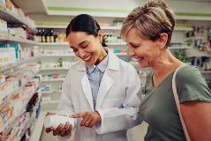 Customer and pharmacist looking at medication
