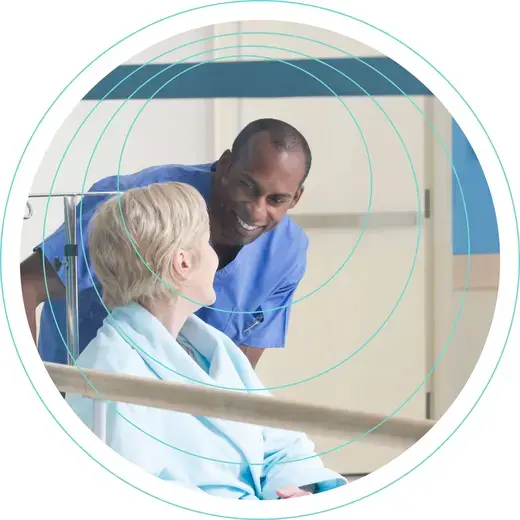 An image used for organisations we oversee showing a nurse with a patient in a corridor